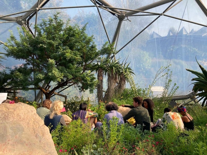 Group seated among plants inside the Eden Project biome