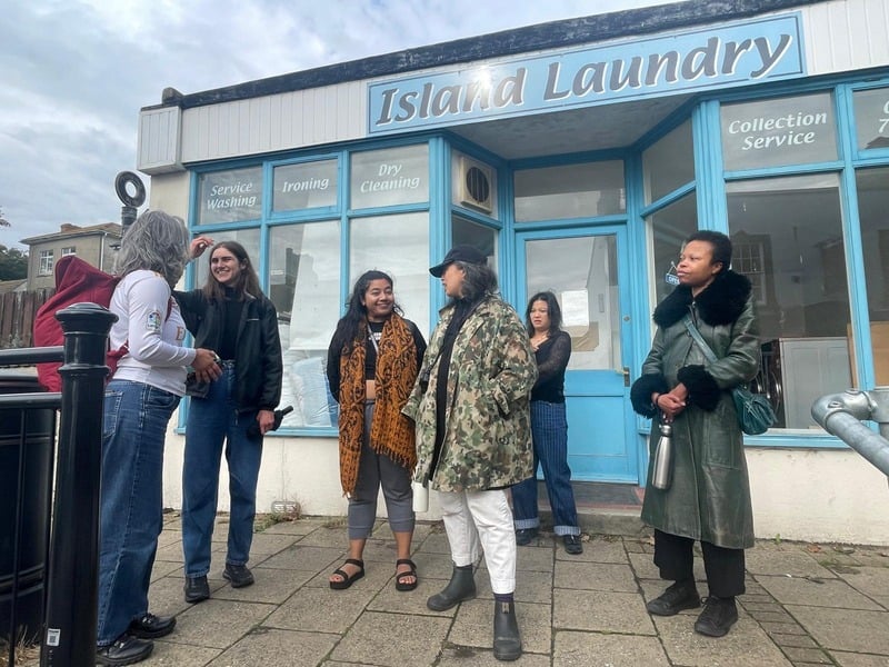 Group of womxn talking outside the Island Laundry on Portland